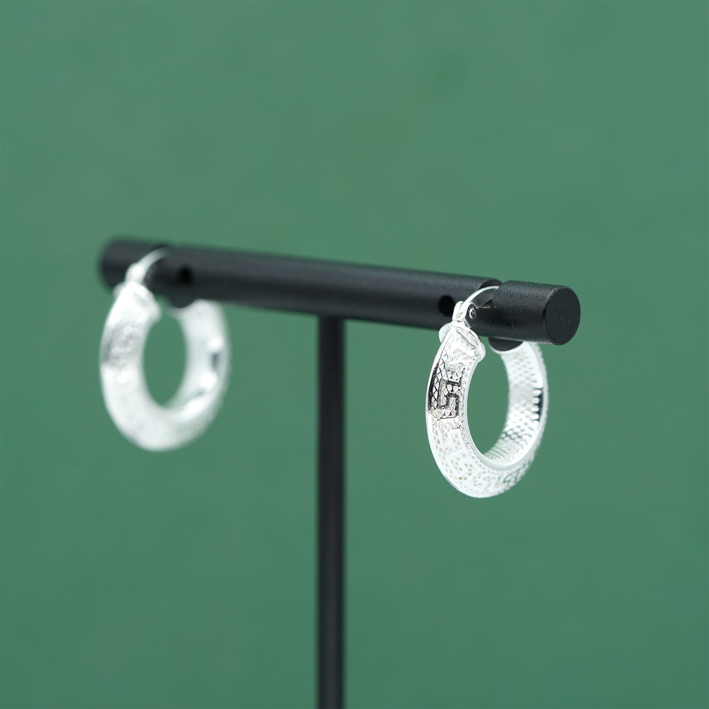 Sterling silver textured hoop earrings crafted from genuine 925 silver.  Patterned surface with chunky hoop profile. Hinged fastening.  Weight: 2g Inner diameter: 10mm Outer diameter: 19mm Width: 4mm  Solid 925 sterling silver.