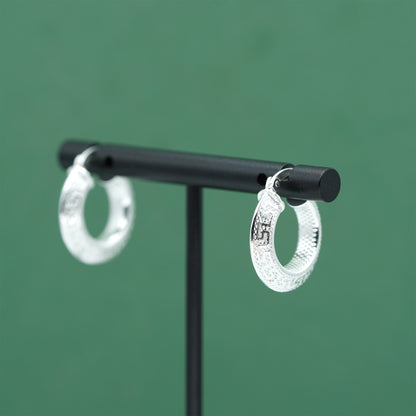 Sterling silver textured hoop earrings crafted from genuine 925 silver.  Patterned surface with chunky hoop profile. Hinged fastening.  Weight: 2g Inner diameter: 10mm Outer diameter: 19mm Width: 4mm  Solid 925 sterling silver.