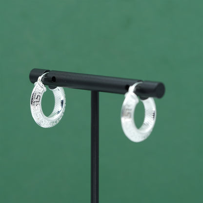 Sterling silver textured hoop earrings crafted from genuine 925 silver.  Patterned surface with chunky hoop profile. Hinged fastening.  Weight: 2g Inner diameter: 10mm Outer diameter: 19mm Width: 4mm  Solid 925 sterling silver.