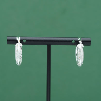 Sterling silver textured hoop earrings crafted from genuine 925 silver.  Patterned surface with chunky hoop profile. Hinged fastening.  Weight: 2g Inner diameter: 10mm Outer diameter: 19mm Width: 4mm  Solid 925 sterling silver.